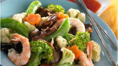 a plate of vegetables and shrimp