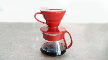 a red coffee filter with a red handle