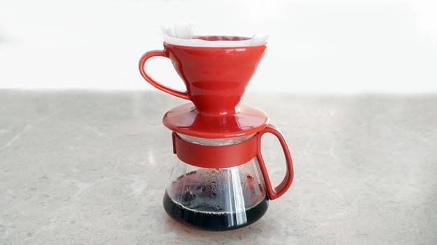 a red coffee filter with a red handle